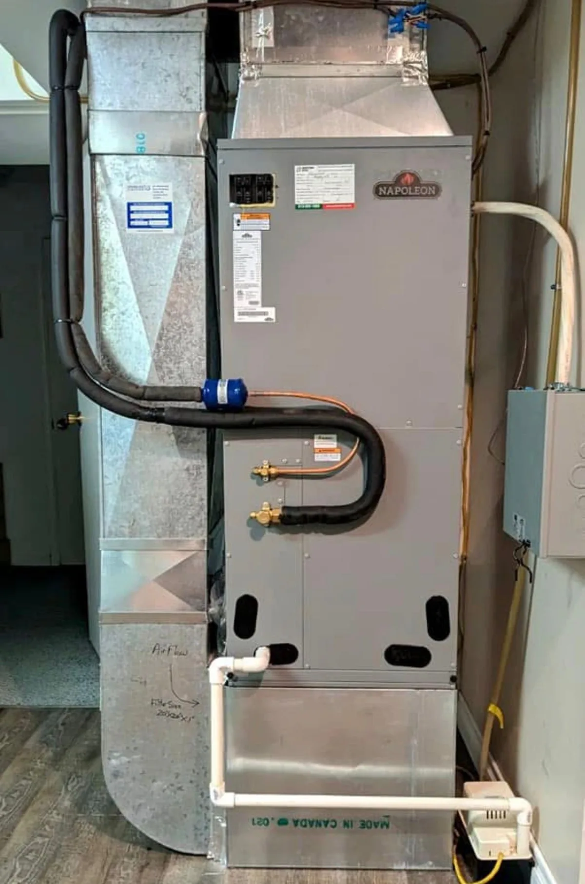 Insulated HVAC refrigerant lines connected beside new ductwork